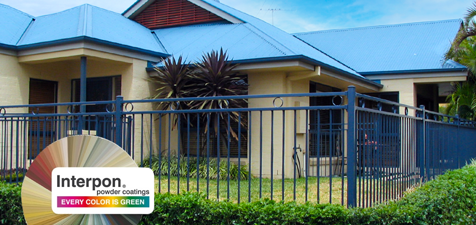 House with a Blue Powder Coated custom Aluminium garden fence surrounding the yard