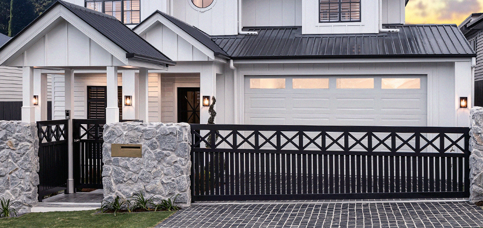 Large home with Aluminium Slat pedestrian gate and driveway sliding gate.