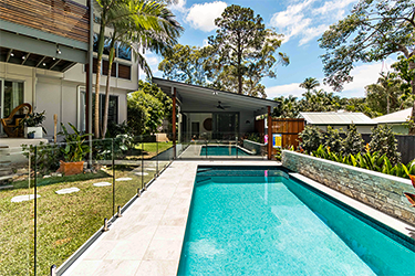 Backyard pool with Frameless Glass fence to the left side
