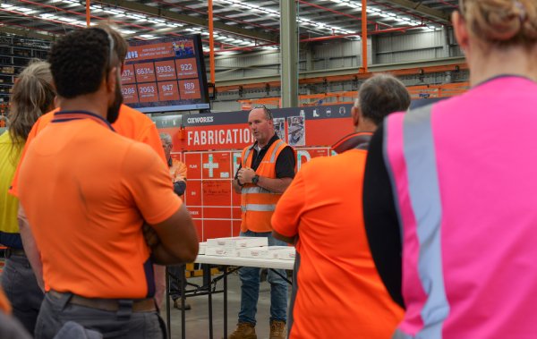 Oxworks staff on the manufacturing floor listening to a presentation